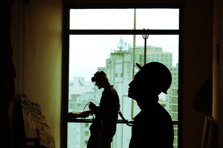 Image of two workers standing on job site to illustrate workplace safety