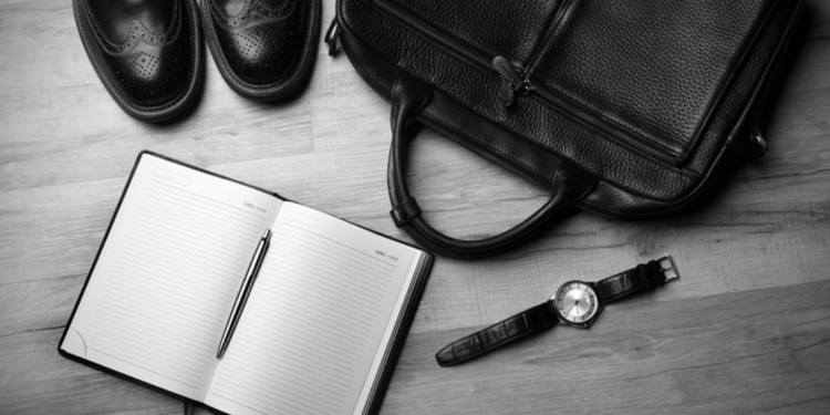 Image of business items and notebook to portray how to get others to read your employee handbook